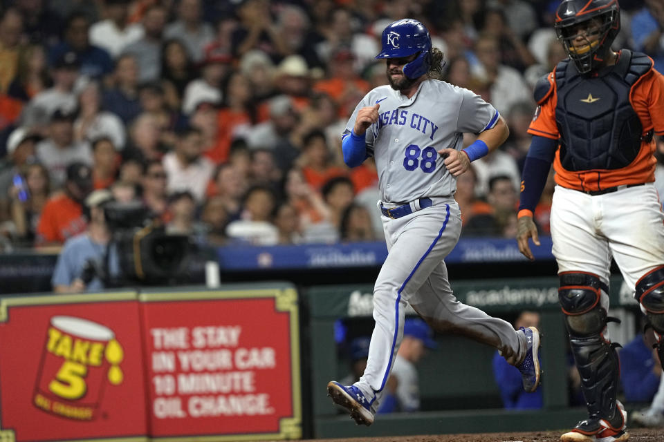 Kansas City Royals' Logan Porter (88) scores as Houston Astros catcher Martin Maldonado stands at home plate during the sixth inning of a baseball game Friday, Sept. 22, 2023, in Houston. (AP Photo/David J. Phillip)