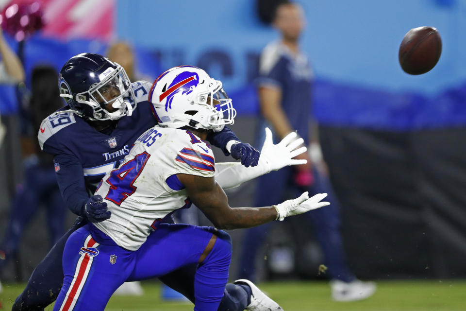 Buffalo Bills wide receiver Stefon Diggs (14) reaches for a pass as he is defended by Tennessee Titans cornerback Breon Borders (39) in the second half of an NFL football game Monday, Oct. 18, 2021, in Nashville, Tenn. (AP Photo/Wade Payne)