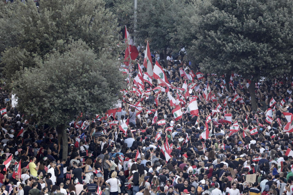 Anti-government protesters shout slogans against the Lebanese government during a protest in Beirut, Lebanon, Saturday, Oct. 19, 2019. The blaze of protests was unleashed a day earlier when the government announced a slate of new proposed taxes, including a $6 monthly fee for using Whatsapp voice calls. The measures set a spark to long-smoldering anger against top leaders from the president and prime minister to the numerous factional figures many blame for decades of corruption and mismanagement. (AP Photo/Hassan Ammar)