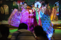 Contestants walk on the ramp for the Miss Trans Northeast 22, beauty pageant in Guwahati, India, Wednesday, Nov. 30, 2022. In a celebration of gender diversity and creative expression, a beauty pageant in eastern Indian state of Assam brought dozens of transgender models on stage in Guwahati. Sexual minorities across India have gained a degree of acceptance especially in big cities and transgender people were given equal rights as a third gender in 2014. But prejudice against them persists and the community continues to face discrimination and rejection by their families. (AP Photo/Anupam Nath)