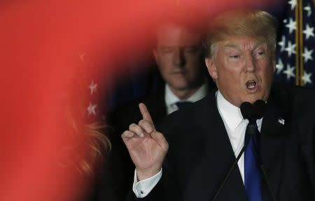 Republican U.S. presidential candidate Donald Trump gestures at his 2016 New Hampshire presidential primary night rally in Manchester, New Hampshire February 9, 2016. REUTERS/Jim Bourg