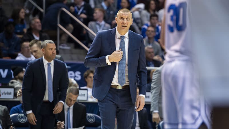 BYU coach Mark Pope, center, talks with one of his players during game against Kansas State, Saturday, Feb. 10, 2024, in Provo, Utah.