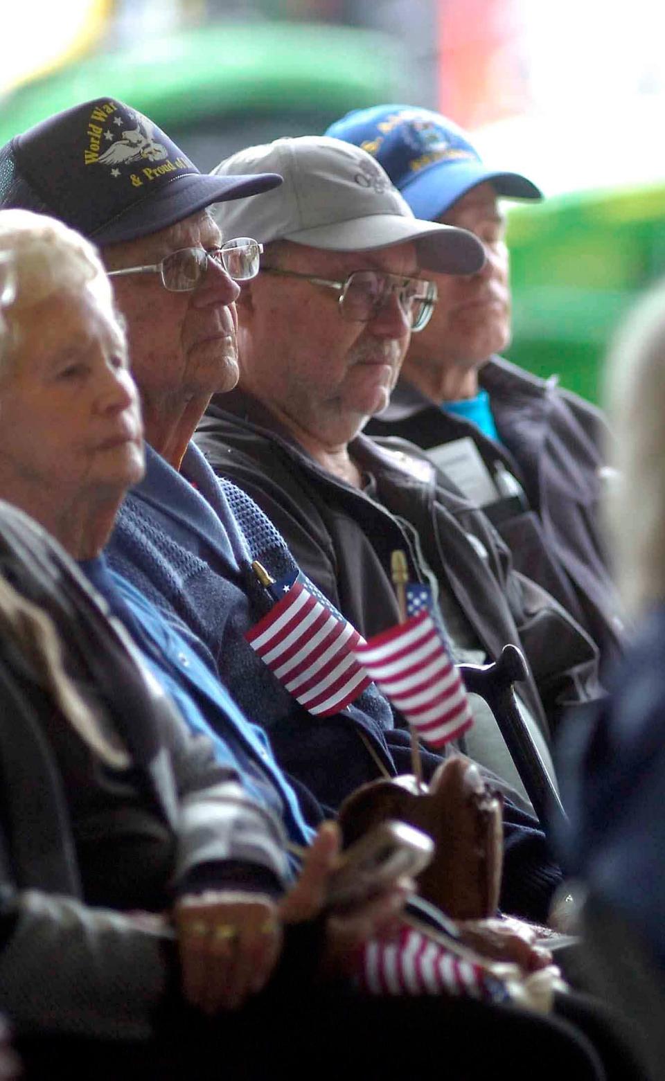 Veterans listen to speaker Greg Gorrell at the veteran program at the fair Monday.