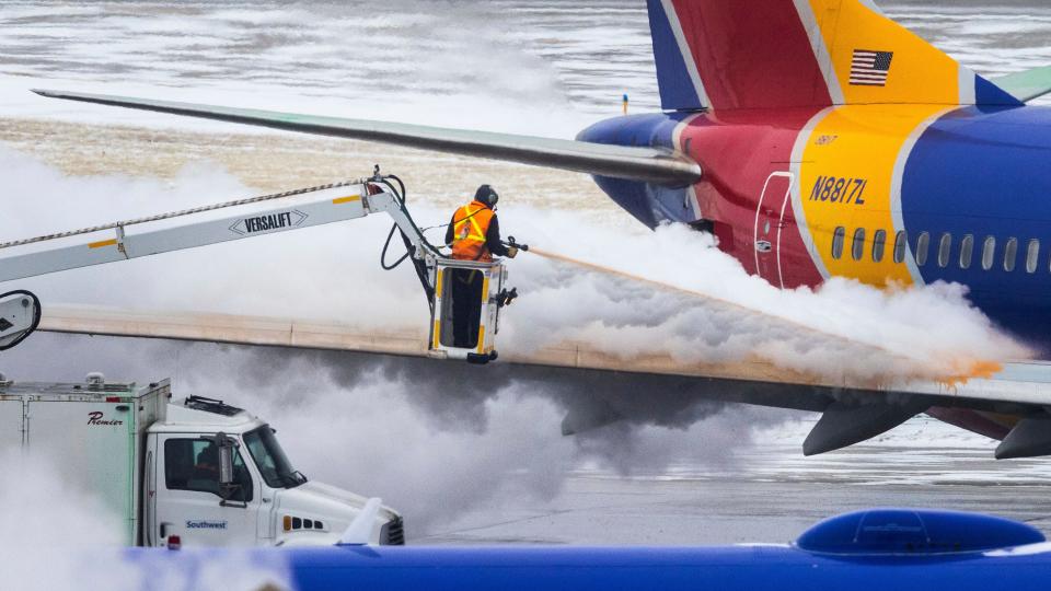 Crews deice a Southwest Airlines plane before takeoff on Wednesday, Dec. 21, 2022 in Omaha, Nebraska.