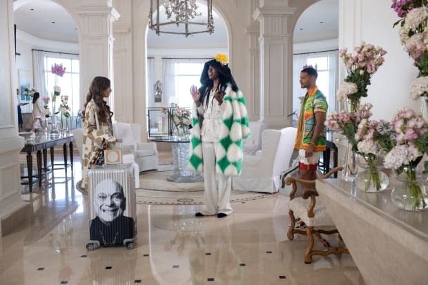 Emily, wheeling her Pierre Cadault x Rimowa suitcase, meets Gregory Elliot Duprée (Jeremy O. Harris, middle) in Saint Tropez.<p>Photo: Carole Bethuel/Courtesy of Netflix</p>