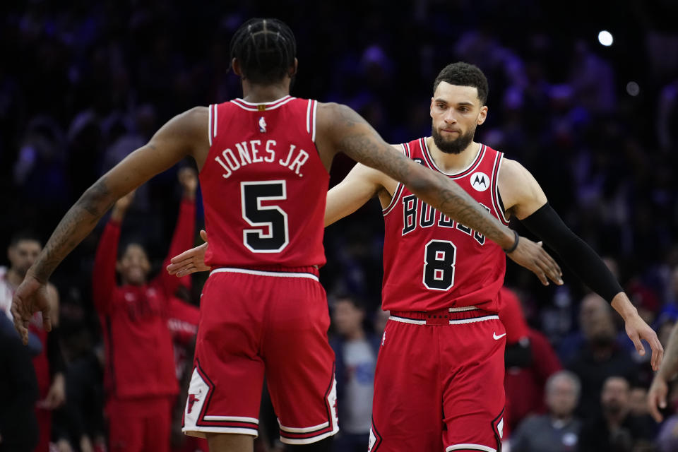 Chicago Bulls' Zach LaVine (8) and Derrick Jones Jr. (5) celebrate during double overtime in an NBA basketball game against the Philadelphia 76ers, Monday, March 20, 2023, in Philadelphia. (AP Photo/Matt Slocum)