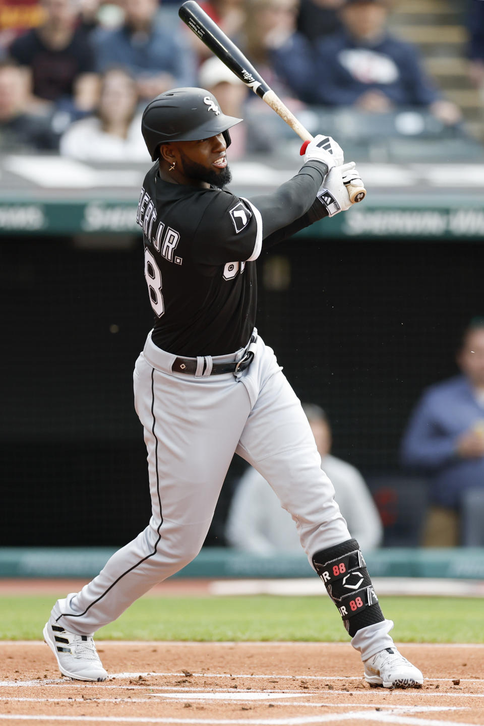 Chicago White Sox's Luis Robert Jr. watches his single off Cleveland Guardians starting pitcher Hunter Gaddis during the first inning of a baseball game, Monday, May 22, 2023, in Cleveland. (AP Photo/Ron Schwane)