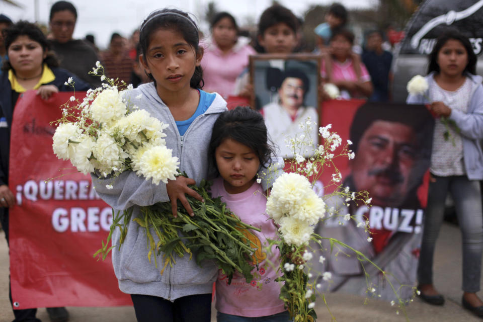 The granddaughters of slain journalist Gregorio Jimenez walk towards the cemetery in Coatzacoalcos, Mexico, Wednesday Feb. 12, 2014. Veracruz state officials concluded that Jimenez, a police beat reporter, was killed in a personal vendetta, unrelated to his reporting. But journalists throughout Mexico are calling for a thorough investigation. Jimenez is the 12th journalist slain or gone missing since 2010 in the Gulf state of Veracruz. (AP Photo/Felix Marquez)