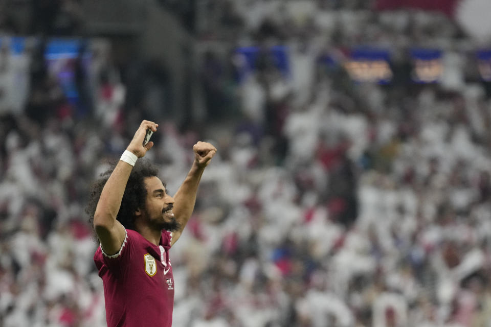 Qatar's Akram Afif celebrates after scoring his side's opening goal during the Asian Cup final soccer match between Qatar and Jordan at the Lusail Stadium in Lusail, Qatar, Saturday, Feb. 10, 2024. (AP Photo/Aijaz Rahi)