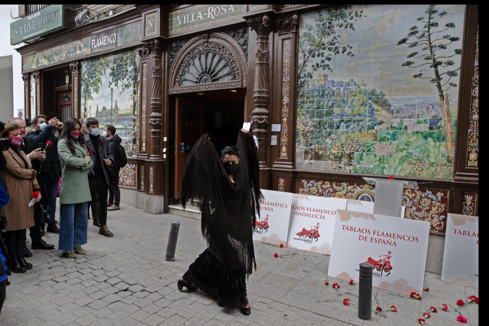 Spanish Flamenco dancer Anabel Moreno dances outside the Villa Rosa Tablao flamenco venue during a protest in Madrid, Spain, Thursday March 4, 2021. The National Association of Tablaos protested outside the mythical Villa Rosa Tablao which has been forced to close permanently due to the covid pandemic. (AP Photo/Paul White)