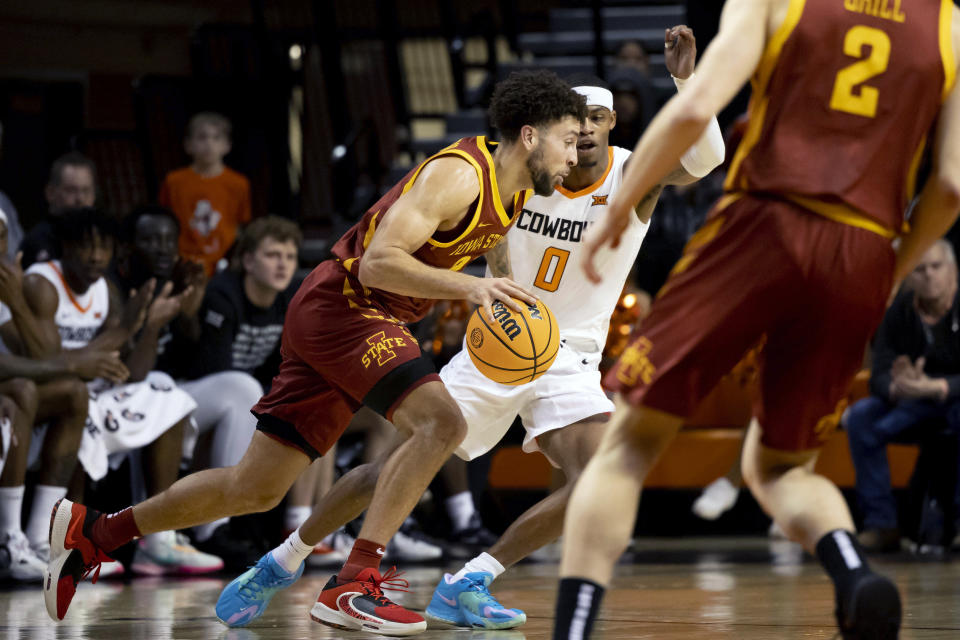 Iowa State's Gabe Kalscheur (22) drives past Oklahoma State's Avery Anderson III (0) in the first half of the NCAA college basketball game in Stillwater, Okla., Saturday, Jan. 21, 2023. (AP Photo/Mitch Alcala)