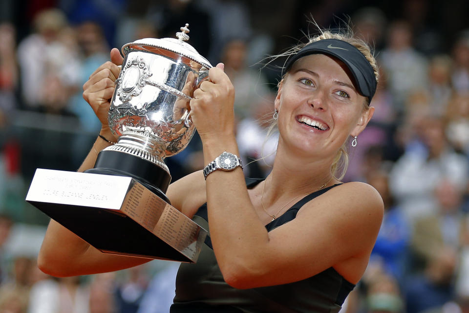 FILE - In this Saturday June 9, 2012 file photo, Maria Sharapova of Russia holds the trophy after winning the women's final match against Sara Errani of Italy at the French Open tennis tournament in Roland Garros stadium in Paris. Two-time French Open champion Maria Sharapova has pulled out of the year’s second Grand Slam tournament because of her injured right shoulder. Sharapova announced her withdrawal on Instagram, on Tuesday, May 14, 2019. (AP Photo/Michel Euler, File)
