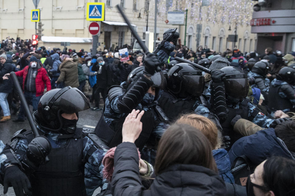 Police officers clash with people during a protest against the jailing of opposition leader Alexei Navalny in Moscow, Russia, Saturday, Jan. 23, 2021. Russian police on Saturday arrested hundreds of protesters who took to the streets in temperatures as low as minus-50 C (minus-58 F) to demand the release of Alexei Navalny, the country's top opposition figure. (AP Photo/Pavel Golovkin)