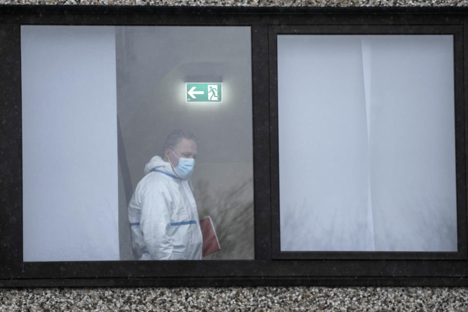 Forensic experts investigates at a Jehovah's Witness building in Hamburg, Germany Friday, March 10, 2023. Shots were fired inside the building used by Jehovah's Witnesses in the northern German city of Hamburg on Thursday evening, with multiple people killed and wounded, police said. (AP Photo/Markus Schreiber)
