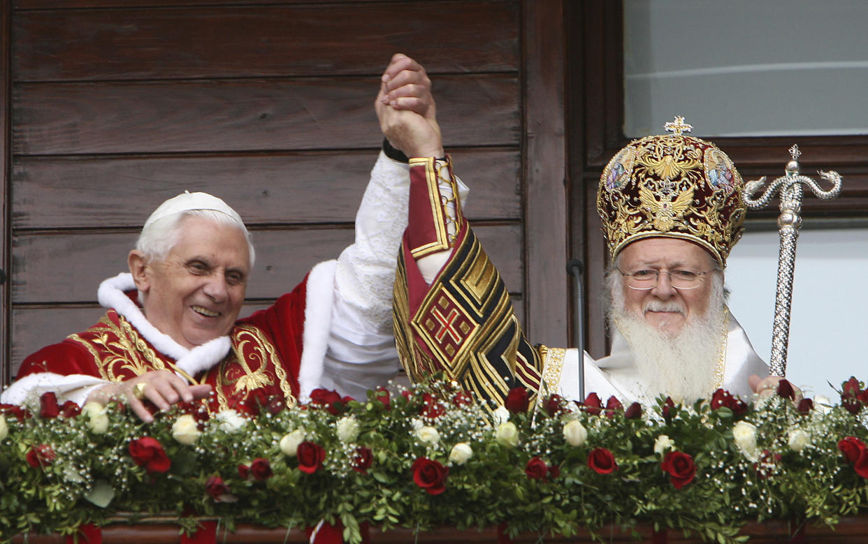 FILE - Pope Benedict XVI, left, and Ecumenical Patriarch Bartholomew I greet the faithful from a balcony of the Ecumenical Patriarchate after attending the Divine Liturgy together in the nearby Church of St. George in Istanbul, Turkey, on Nov. 30, 2006. Pope Emeritus Benedict XVI, the German theologian who will be remembered as the first pope in 600 years to resign, has died, the Vatican announced Saturday. He was 95. (AP Photo/Dimitri Messinis, File)