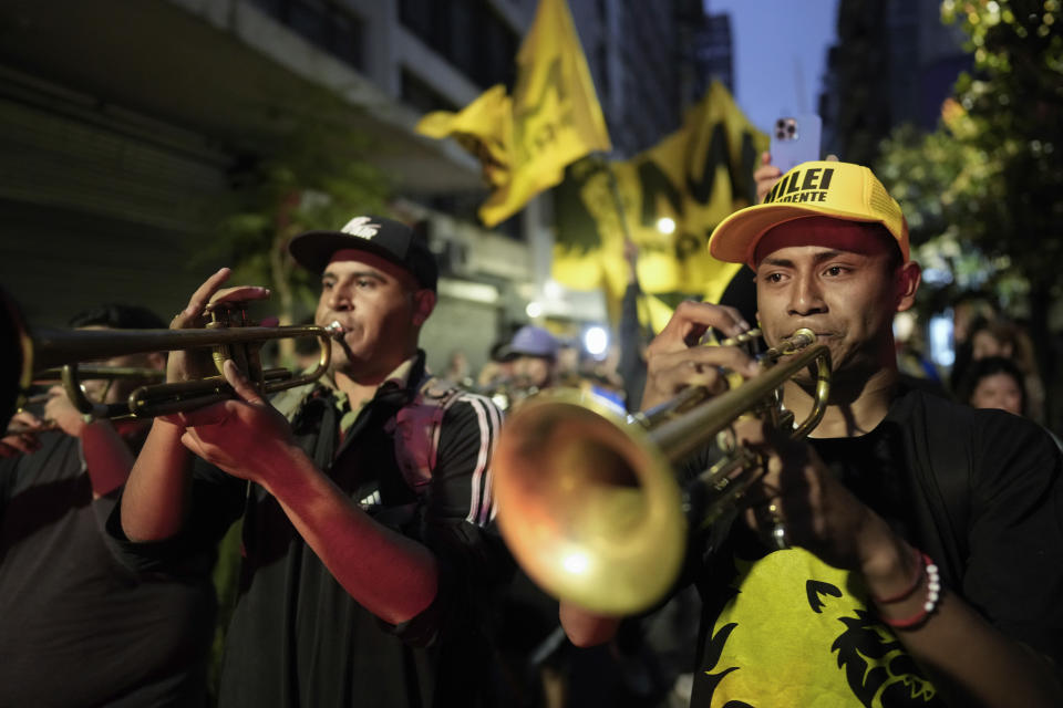 Supporters of Javier Milei, presidential candidate of the Liberty Advances coalition, gather outside his campaign headquarters after polls closed for general elections in Buenos Aires, Argentina, Sunday, Oct. 22, 2023. (AP Photo/Rodrigo Abd)