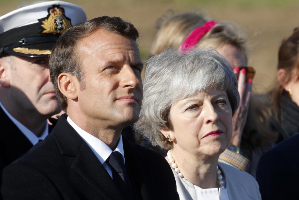 British Prime Minister Theresa May and French President Emmanuel Macron attend a Franco-British ceremony to mark the 75th anniversary of D-Day landings and laying the first stone of a British memorial at Ver-Sur-Mer, Normandy, Thursday, June 6, 2019.(Philippe Wojazer/Pool via AP)