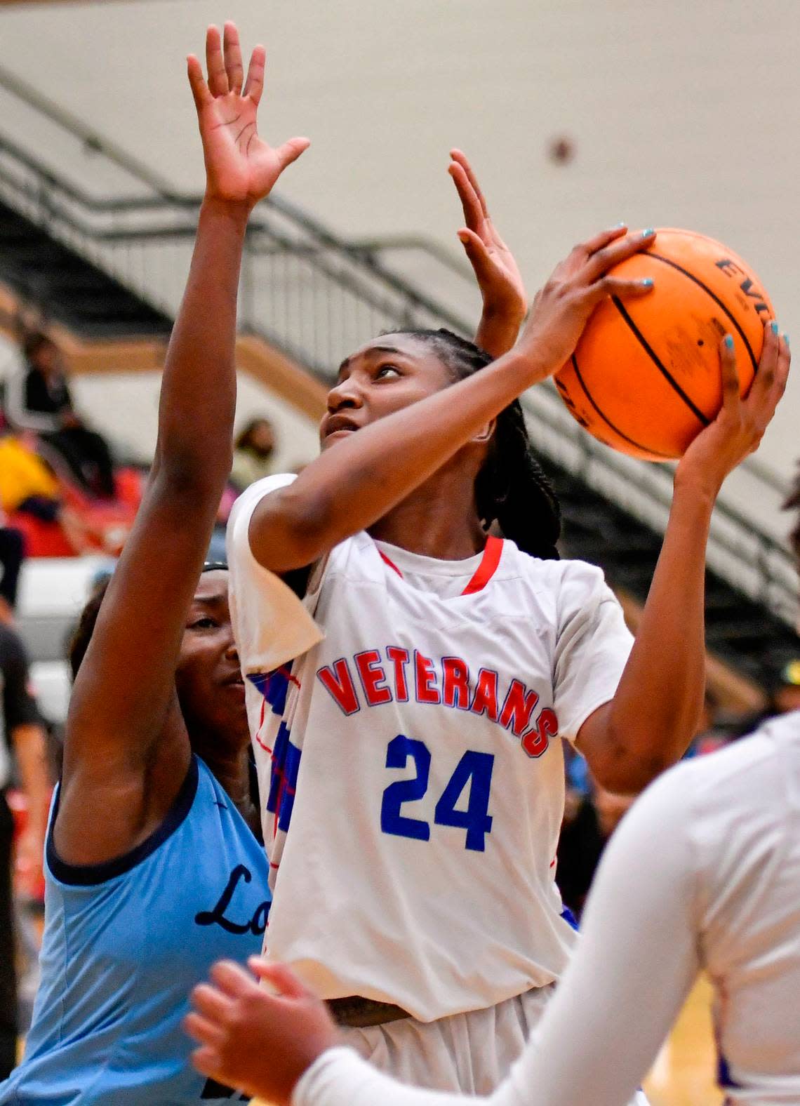 Veterans’ Gabby Minus (24) puts up a shot over a Lovejoy defender during their GHSA second round playoff game Friday night. Lovejoy defeated Veterans 72-53.