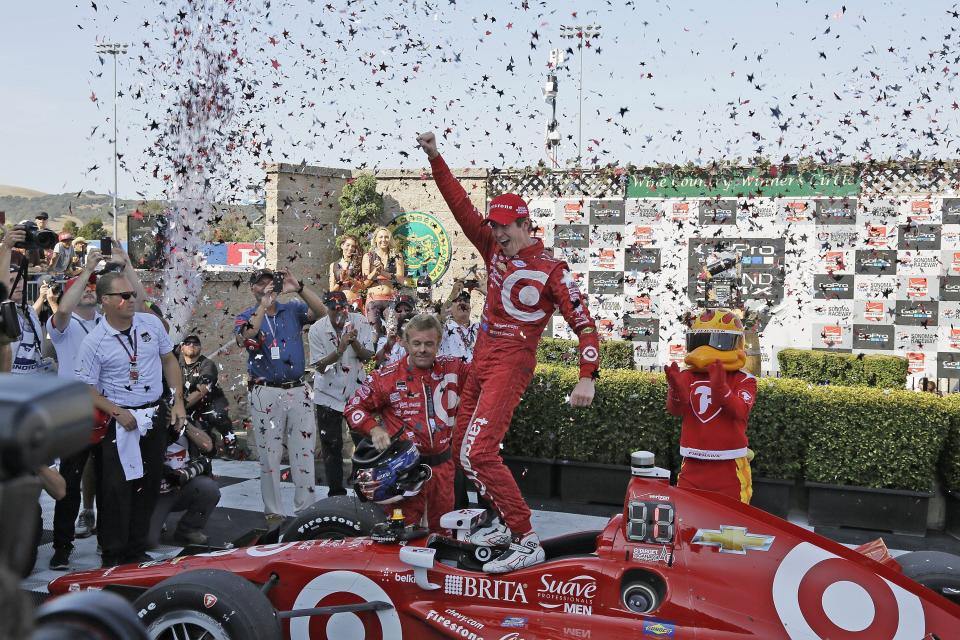 FILE - In this Aug. 30, 2015, file photo, Scott Dixon, of New Zealand, celebrates atop his car after winning the IndyCar Grand Prix of Sonoma auto race and IndyCar championship, in Sonoma, Calif. Chip Ganassi knew Scott Dixon as a quiet kid in a paddock full of superstars when he hired him four races into the 2002 season. The pairing has since produced the most celebrated driver of his generation. (AP Photo/Eric Risberg, File)