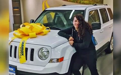 Angela Hernandez posing with a Jeep before the crash