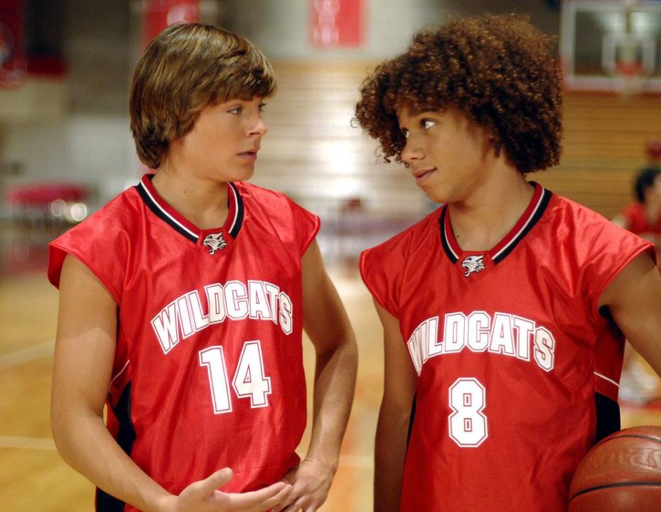 zac efron and corbin bleu in high school musical as troy and chad, in their red basketball outfits