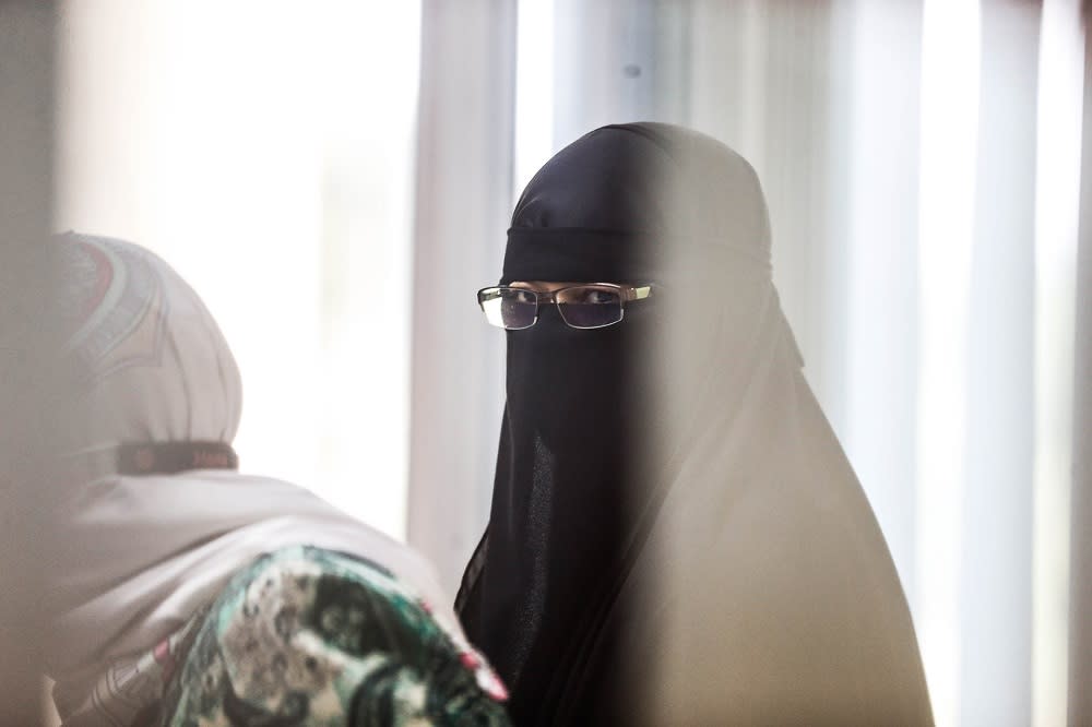 Universiti Sains Malaysia assistant administrative officer Zurina Abdul Hamid is led to the Sessions Court in Butterworth September 28, 2020. — Picture By Sayuti Zainudin