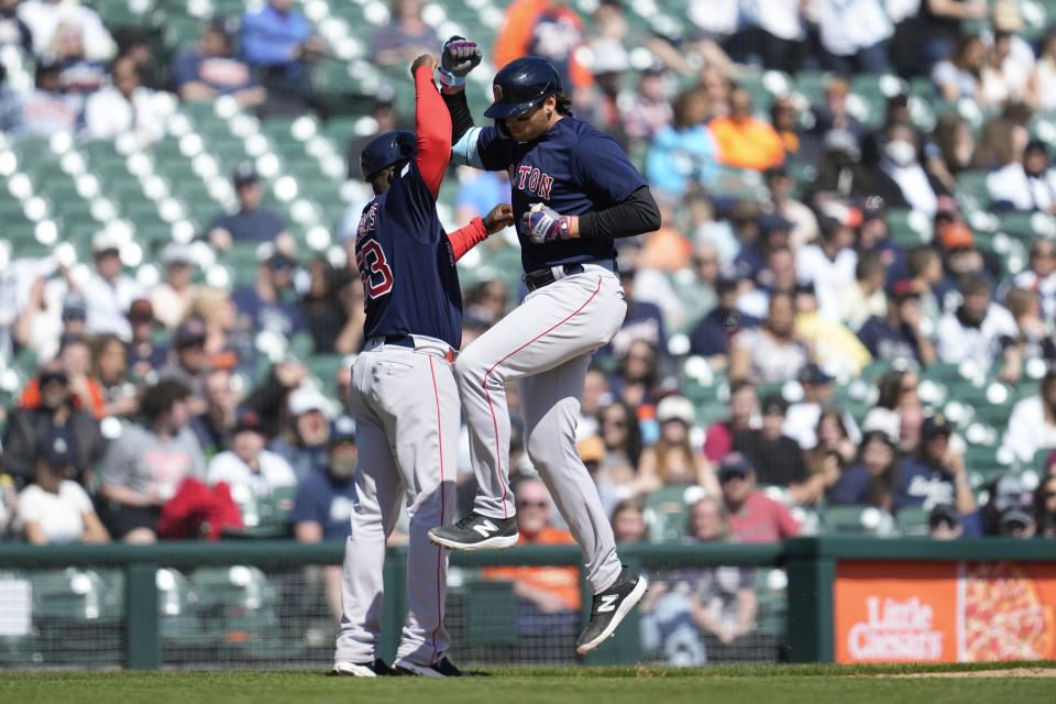 Boston Red Sox first baseman Triston Casas, right, celebrates his home run with third base coach Carlos Febles in the ninth inning of a baseball game against the Detroit Tigers in Detroit, Sunday, April 9, 2023. (AP Photo/Paul Sancya)