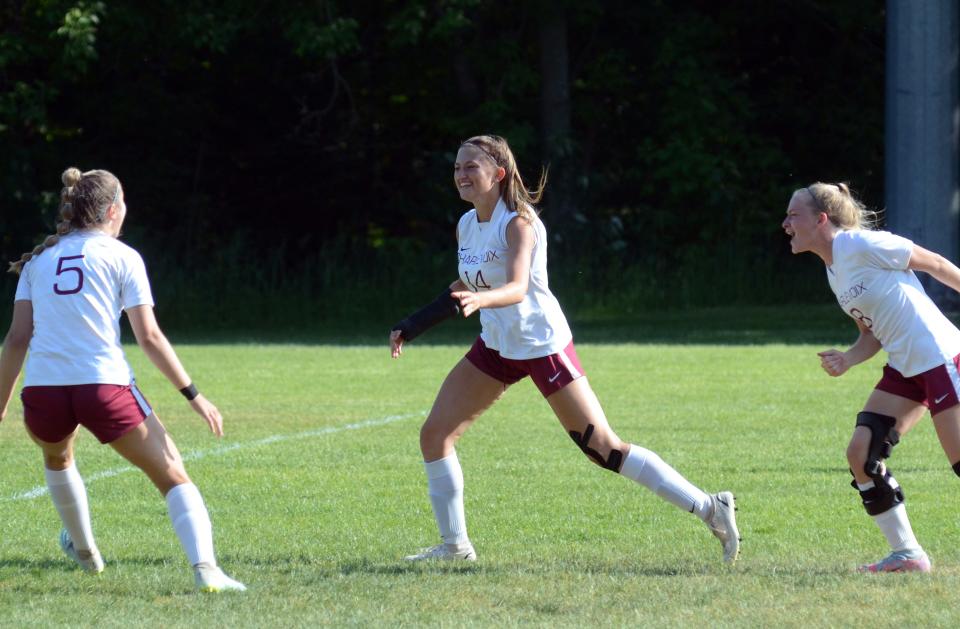 Charlevoix senior Mikayla Sharrow (middle) celebrates with teammates Karlee Eaton (right) and Kylee Rice (left) after scoring just seconds into the game Friday.