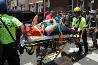 <p>Rescue workers move victims on stretchers after car plowed through a crowd of counter-demonstrators marching through the downtown shopping district Aug. 12, 2017 in Charlottesville, Va. (Photo: Chip Somodevilla/Getty Images) </p>