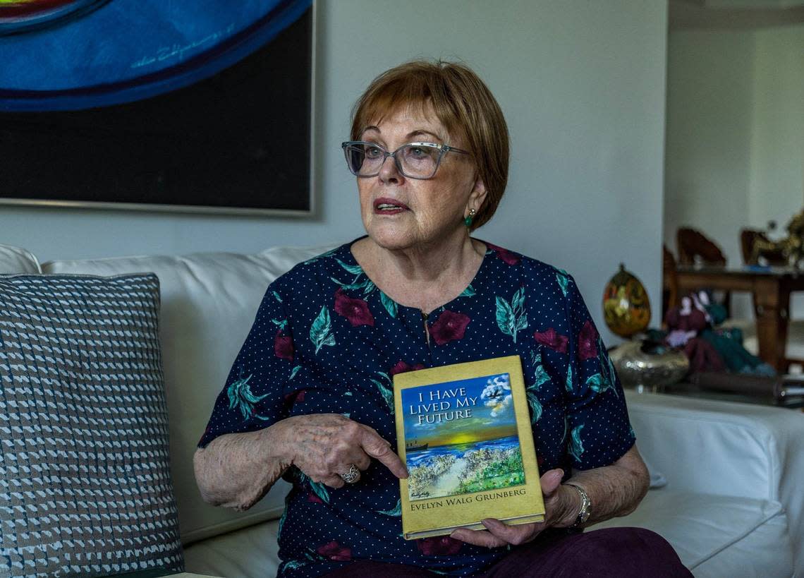 Evelyn Walg Grunberg displays a book she wrote about her family history and their escape from Nazism during the Holocaust in 1942.
