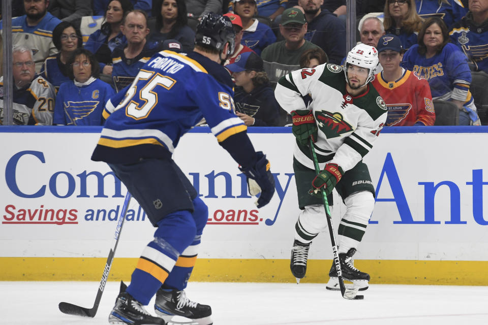 Minnesota Wild's Kevin Fiala (22) is defended by St. Louis Blues' Colton Parayko (55) during the first period in Game 3 of an NHL hockey Stanley Cup first-round playoff series Friday, May 6, 2022, in St. Louis. (AP Photo/Michael Thomas)