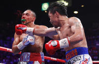 Manny Pacquiao, right, lands a punch against Keith Thurman in the fifth round during a welterweight title fight Saturday, July 20, 2019, in Las Vegas. (AP Photo/John Locher)