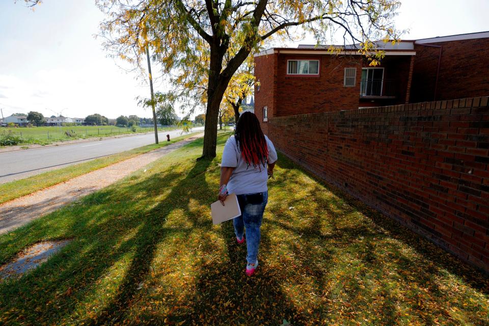 Tenesa Sanders, 48 of Detroit and the lead organizer for Detroit Action, heads to another location on Saturday, October 9, 2021 with a flyer about legal help for those facing eviction in Detroit.