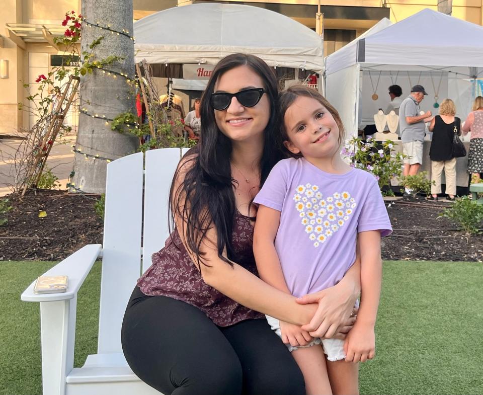 Gala Hejni, Josh Luizzi and their daughter Lianna enjoy an evening at Mercato in Naples. Hejni said they spend time at Mercato every couple of months, usually when there is an event such as the art show on this Saturday in January.