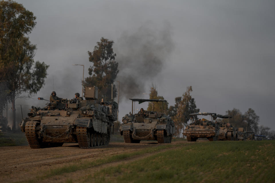 A convoy of Israeli army armoured personnel carriers (APC) moves near the Israeli-Gaza border, in southern Israel, Monday, Dec. 25, 2023. The army is battling Palestinian militants across Gaza in the war ignited by Hamas' Oct. 7 attack into Israel. (AP Photo/Leo Correa)