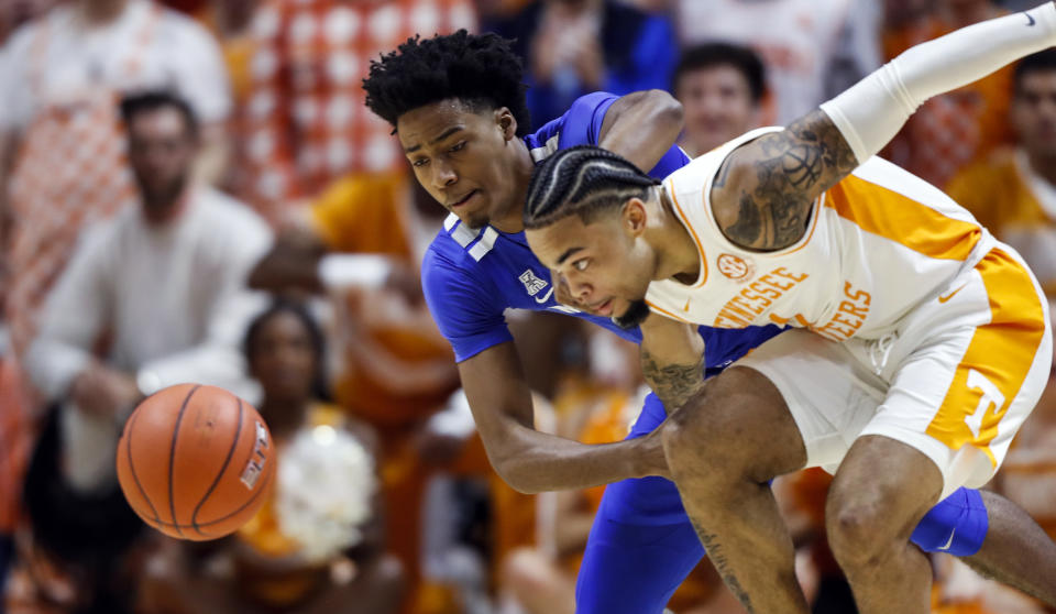 Tennessee guard Lamonte Turner (1) battles for the loose ball with Memphis guard Jayden Hardaway (25) during the first half of an NCAA college basketball game Saturday, Dec. 14, 2019, in Knoxville, Tenn. (AP Photo/Wade Payne)