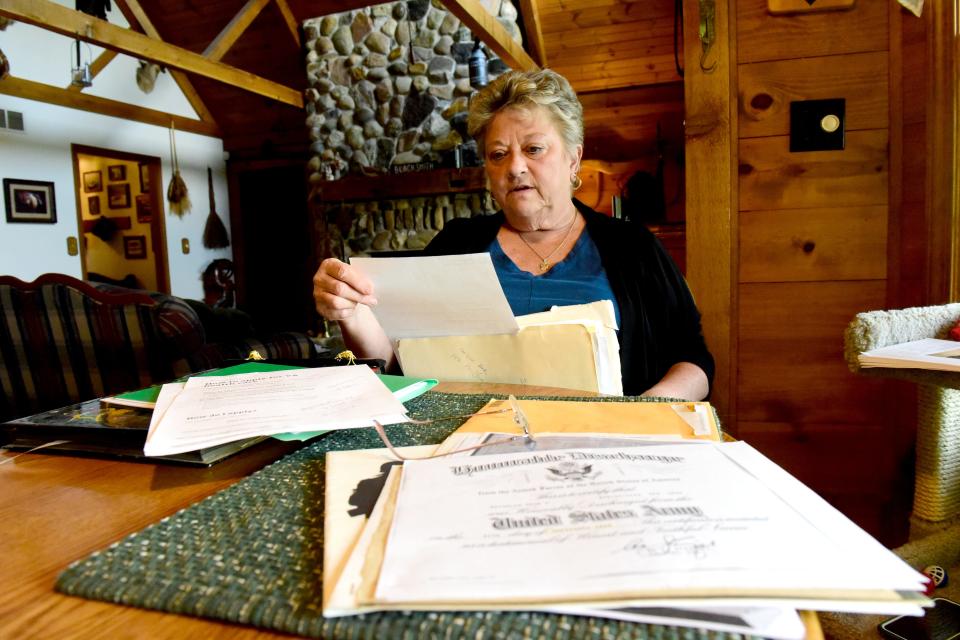 Diane Reynolds of Ashland looks over Army documentation from her late husband, Gene, who served from 1963 to 1969. Gene was in Korea during the Vietnam War.