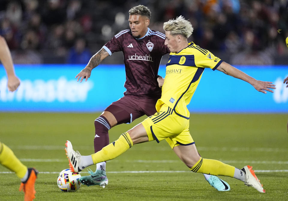 Colorado Rapids forward Rafael Navarro, left, and Nashville SC defender Lukas MacNaughton, right, battle for the ball during the first half of an MLS soccer match Saturday, March 2, 2024, in Commerce City, Colo. (AP Photo/David Zalubowski)