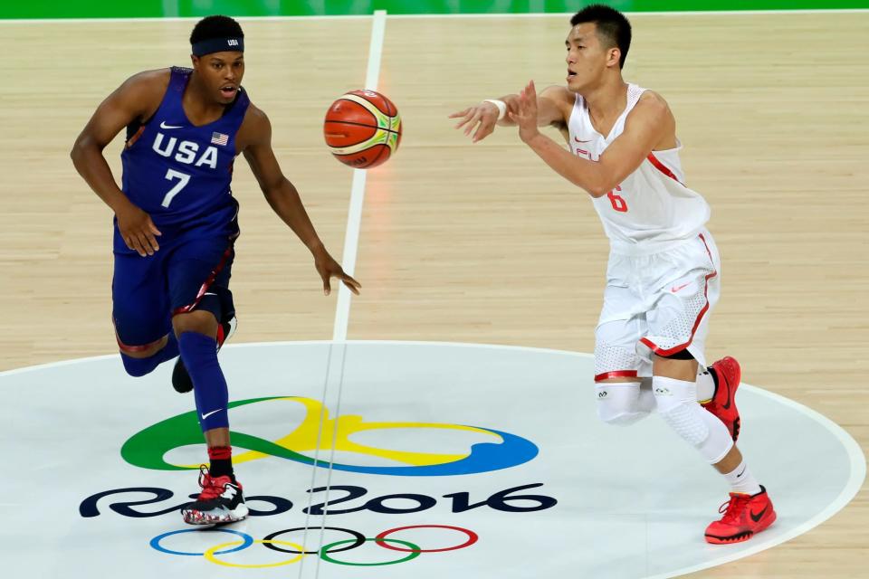 <p>Ailun Guo #6 of China passes the ball around Kyle Lowry #7 of United States on Day 1 of the Rio 2016 Olympic Games at Carioca Arena 1 on August 6, 2016 in Rio de Janeiro, Brazil. (Photo by Jamie Squire/Getty Images) </p>