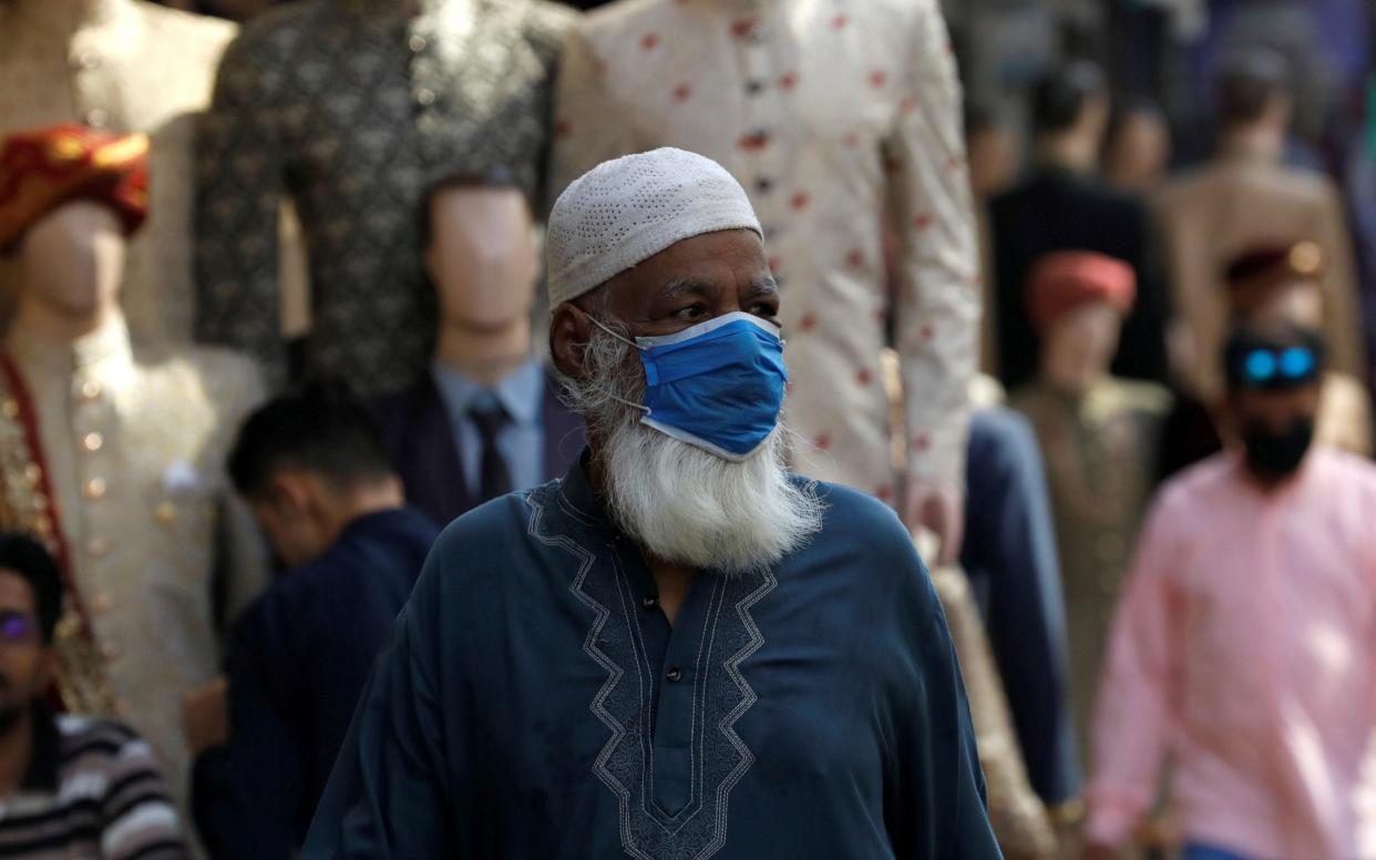 A man wears a protective face mask as the outbreak of the coronavirus disease continues, in Karachi, Pakistan.  - Akhtar Soomro /Reuters 