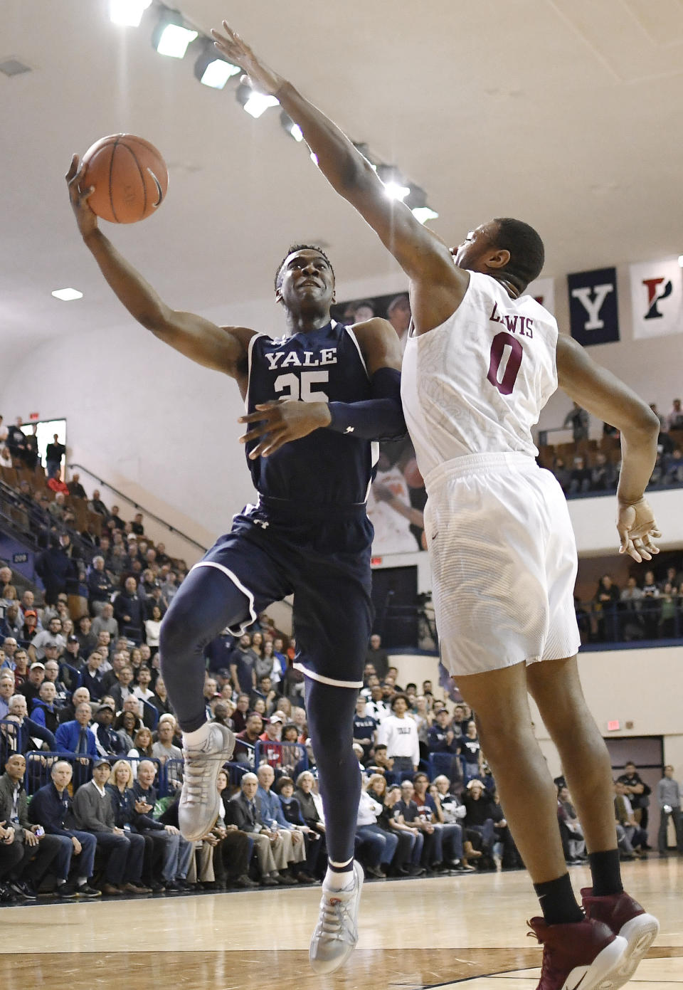 Yale's Miye Oni, left, shoots as Harvard's Chris Lewis, right, defends during the first half of an NCAA college basketball game in a for the Ivy League championship at Yale University in New Haven, Conn., Sunday, March 17, 2019, in New Haven, Conn. (AP Photo/Jessica Hill)