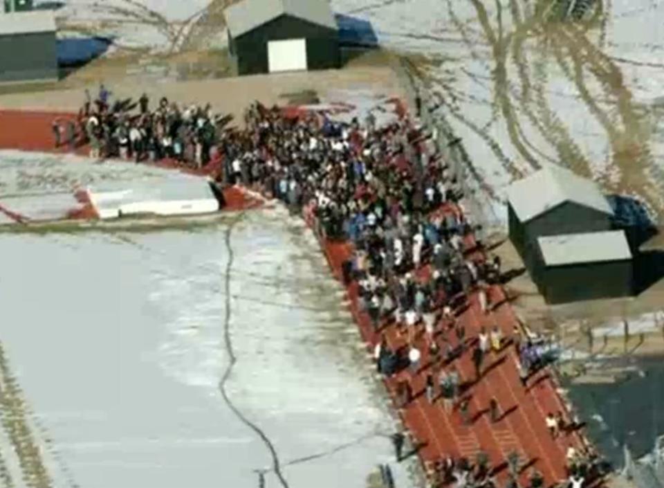 Students from Arapahoe High School evacuate their building in Centennial, Colorado December 13, 2013 in this still image from video Courtesy KUSA, Channel 9 during a shooting incident in which at least two students were injured. Police reported the gunman took his own life. REUTERS/Courtesy KUSA, Channel 9 (UNITED STATES - Tags: CRIME LAW) NO SALES. NO ARCHIVES. FOR EDITORIAL USE ONLY. NOT FOR SALE FOR MARKETING OR ADVERTISING CAMPAIGNS. THIS IMAGE HAS BEEN SUPPLIED BY A THIRD PARTY. IT IS DISTRIBUTED, EXACTLY AS RECEIVED BY REUTERS, AS A SERVICE TO CLIENTS