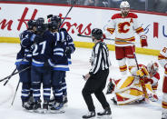 Winnipeg Jets celebrate a goal by Tyler Toffoli (73) against the Calgary Flames during the second period of an NHL hockey game Thursday, April 4, 2024, in Winnipeg, Manitoba. (John Woods/The Canadian Press via AP)