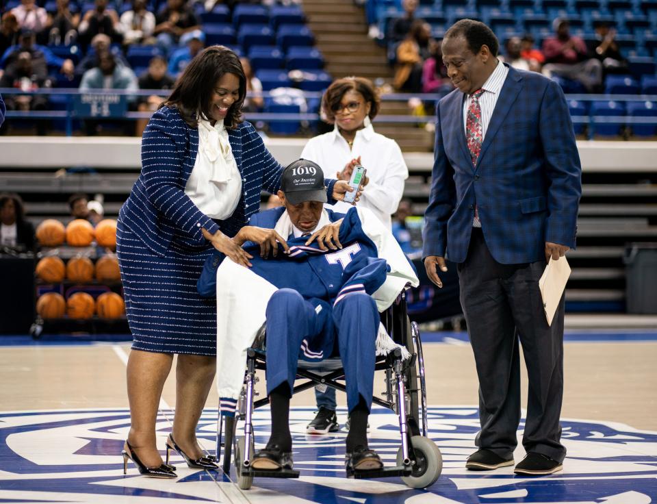 Tennessee State University President Glenda Glover, left, presents a jacket to Dick Barnett during halftime of a basketball game at TSU’s Gentry Center in Nashville, Tenn., Thursday, Feb. 9, 2023. Barnett played for Tennessee A&I before playing professionally for teams including the Syracuse Nationals, Los Angeles Lakers and New York Knicks.