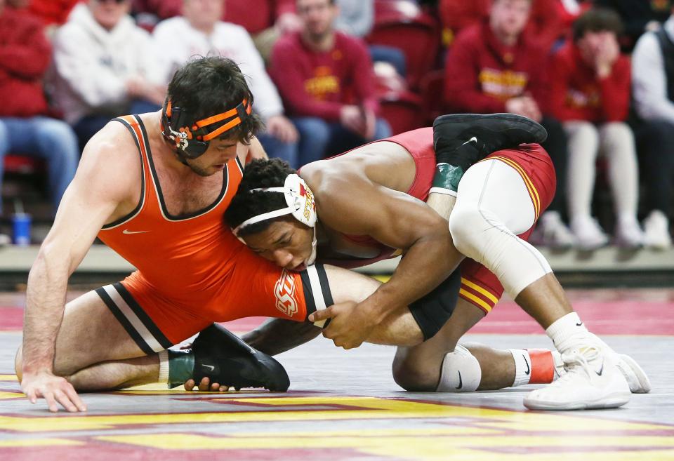 Iowa State Cyclones David Carr goes for a take-down Oklahoma State Cowboys Wyatt Sheets.