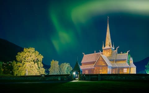 A village church under the Northern Lights in Norway - Credit: Getty