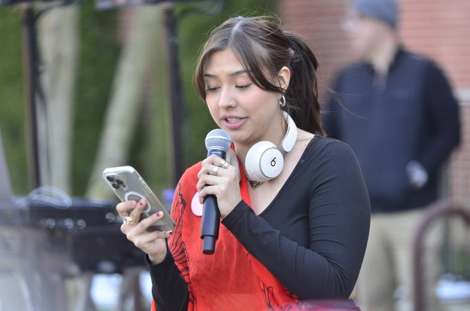 Jennifer Calderón, a student at Earlham, reads a love letter she wrote for her professors off her phone at a protest in support of Earlham College's professors' efforts to unionize at the "Heart" of campus Wednesday afternoon, Feb. 21, 2024.