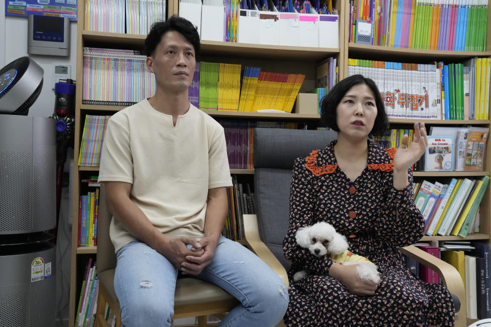 Seo Ji Seong, right, and her husband Kim Dong Uk speaks during an interview at their home in Anyang, South Korea, Sunday, Oct. 9, 2022. Many young people in South Korea have chosen not to marry or have children, citing a change of views toward a marriage and family life and uncertainty of their future. (AP Photo/Lee Jin-man)