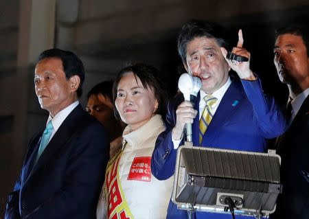 Japan's Prime Minister Shinzo Abe, leader of the Liberal Democratic Party, and Japan's Deputy Prime Minister Taro Aso (L) attend an election campaign rally in Tokyo, Japan October 21, 2017. REUTERS/Kim Kyung-Hoon