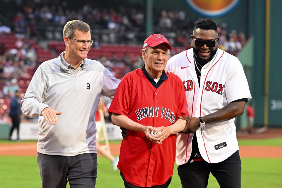 BOSTON, MASSACHUSETTS - AUGUST 29: Former Red Sox president Larry Lucchino, current president Sam Kennedy, and former player David Ortiz walk off of the field after a pregame ceremony before a game against the Houston Astros at Fenway Park on August 29, 2023 in Boston, Massachusetts. (Photo by Brian Fluharty/Getty Images)